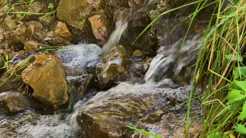 Small waterfall in a mountain stream Stock Footage 159571105