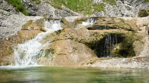 A small waterfall of a mountain stream in a forest (slow motion, bokeh) Stock-Footage 219634376