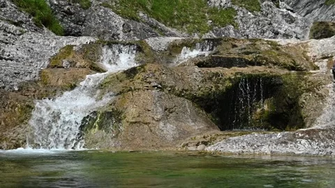 A small waterfall of a mountain stream in a forest (slow motion) Stock-Footage 219634378