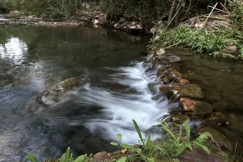 A small waterfall in a mountain stream Stock Photos