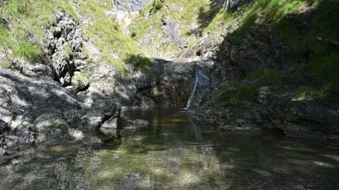 Small waterfall from a mountain stream in the shade of the summer sun Stock-Footage 260846003