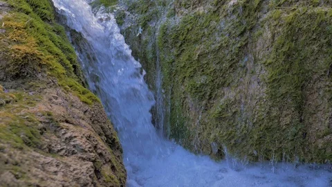 Small waterfall of mountain stream water in slow motion Stock Footage 124384721
