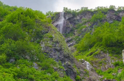 Small waterfall in the mountains in summer Stock Photos