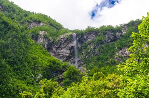 Small waterfall in the mountains in summer Stock Photos