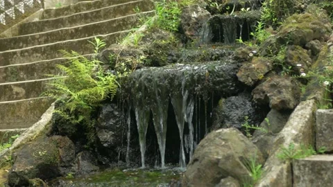 Small waterfall next to beautiful stone stairs Stock Footage 170459421