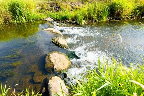 A Small waterfall next to a rock through a small stream Foto stock