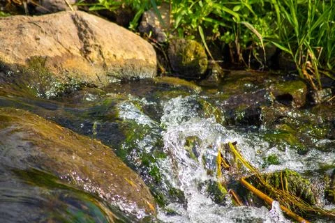 A Small waterfall next to a rock through a small stream Foto stock