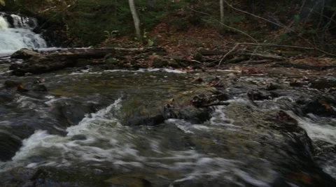 Small waterfall pan from middle of river Stock Footage 44231131