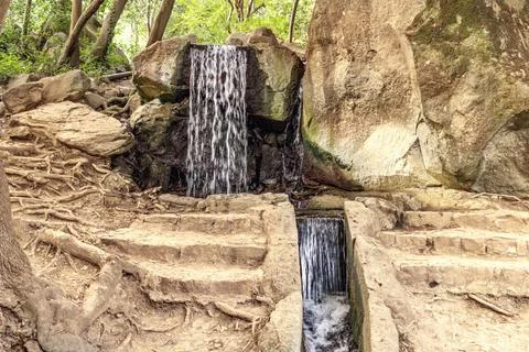 Small waterfall in the Park. Summer Stock Photos