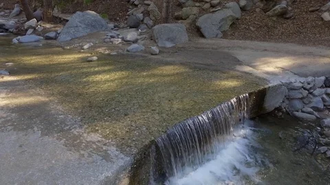 Small waterfall pouring down to a creek 動画素材 73436933