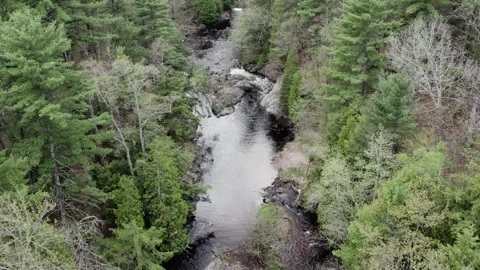 Small waterfall on a quite river 4k, slow-mo drone shot Stock Footage 243541231