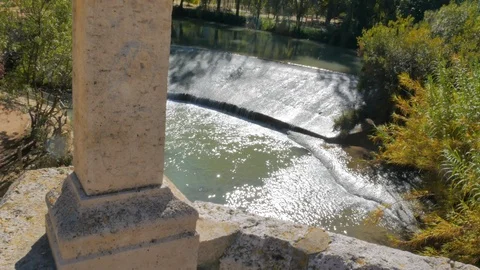 Small waterfall in recreation area in medieval stone bridge Stock Footage 124391150