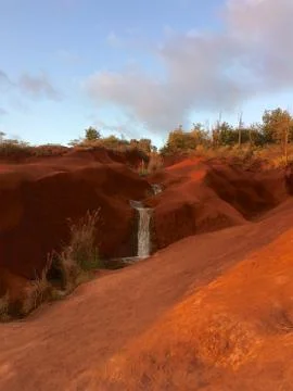 Small waterfall on red soil Stock Photos