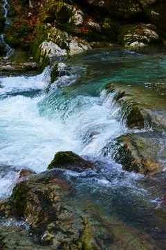 Small waterfall on a river with blue clean water in a wild forest Stock-Fotos