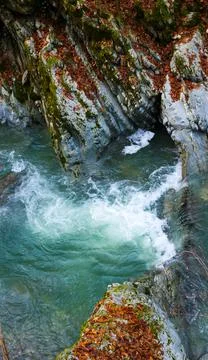 Small waterfall on a river with blue clean water in a wild forest 写真素材