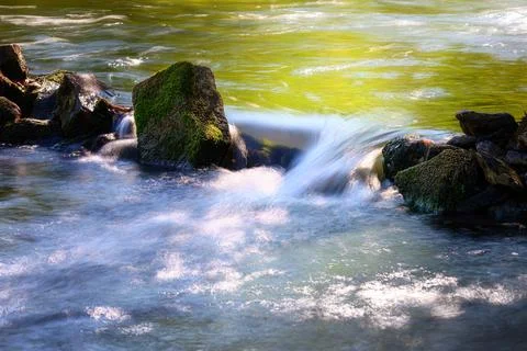 Small waterfall in a river Stock Photos