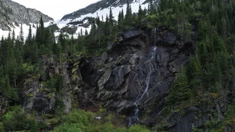 Small waterfall on rock face in mountains Stock Footage 167117080