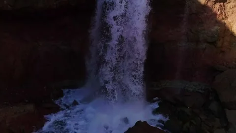 Small waterfall in the rocky gorge. Closeup filmed by drone Stock Footage 198643918