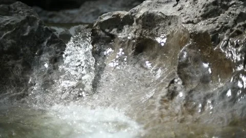 Small waterfall from a rocky mountain river, shot at f1.8 (slow motion) Stock-Footage 212740624