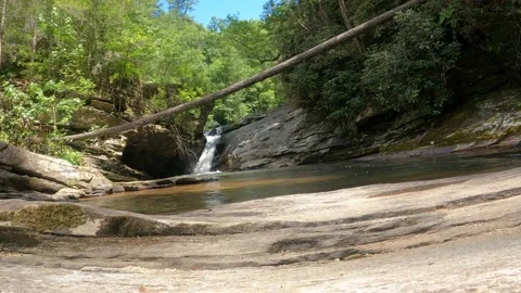 Small waterfall running in the forest with some rocks Stock Footage 160132046