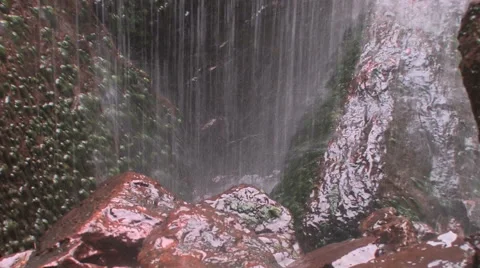A small waterfall showers down on mossy rocks at Zion National Park 스톡 동영상 55735181
