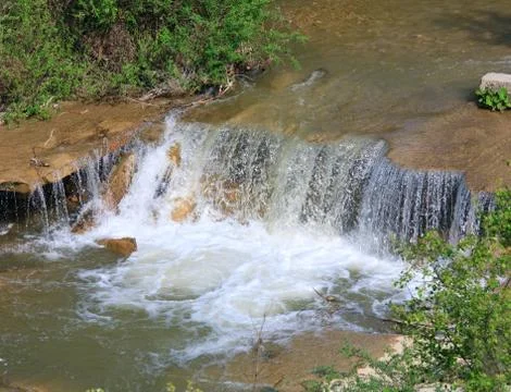 Small waterfall on spring river 스톡 사진