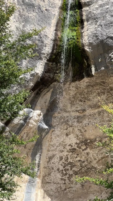 Small waterfall with a steep cliff. View from the top Stock Footage 293318033