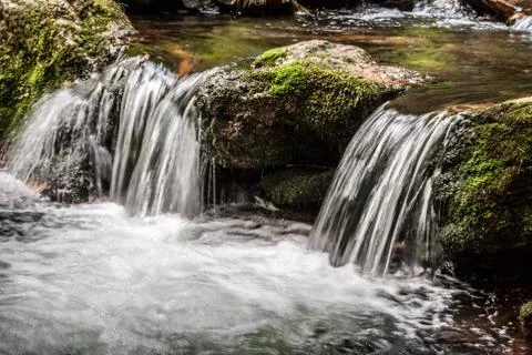 Small waterfall with stone covered by moss on Bila Opava river in Jeseniky mo Stock Photos