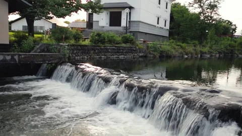 A small waterfall in a stream at a park Stock Footage 249806025