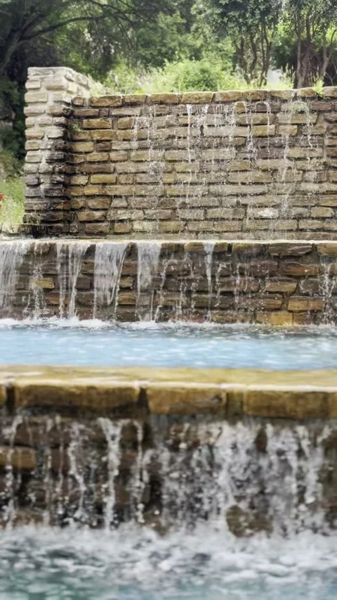 Small waterfall surrounded by lush greenery in Parque de San Amaro in Ceuta Stock Footage 311644757