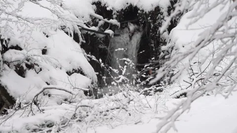 Small Waterfall Surrounded by Snow Covered Landscape 動画素材 315895012
