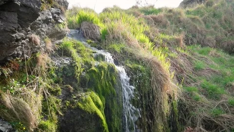 Small waterfall through a rocky cliff, Scotland. Stock Footage 304643063