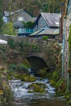 Small waterfall under the stone bridge Stock Photos