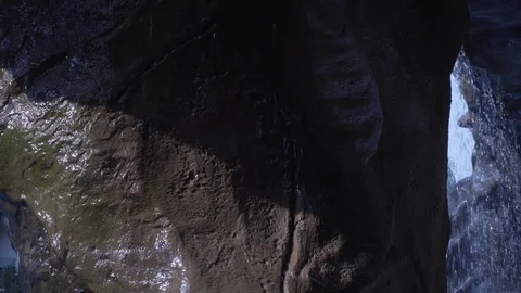 A small waterfall. Water slowly flows down a large stone. Close-up Vídeo Stock 118599770