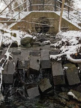 Small Waterfall on a Winter Creek Under a Concrete Bridge 写真素材