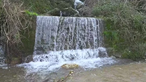 Small waterfall wit green leafs around ,stedy shot Stock Footage 266402211