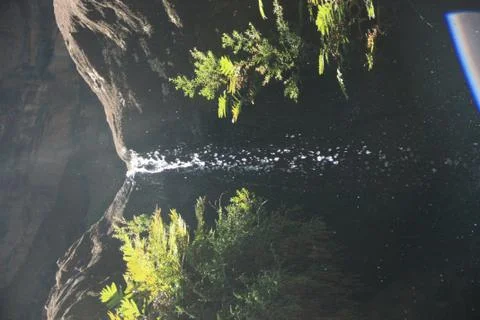 Small waterfall with zenith light Foto stock
