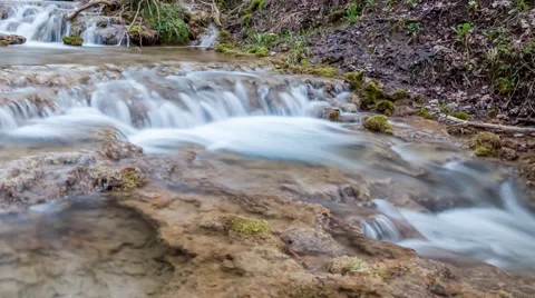 Small waterfalls on crystal clear mountain river. Camera easy panning Stock Footage 62965462