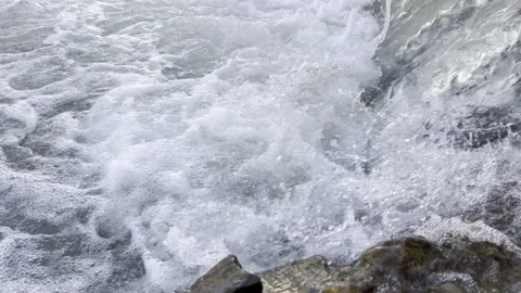 Small waterfalls from under a bridge on a mountain river, late morning. Stock Footage 330498793