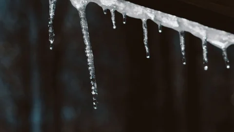 Small water's drops falls down from ice stick. Slow Motion. Tripod shot. Stock Footage 94060304
