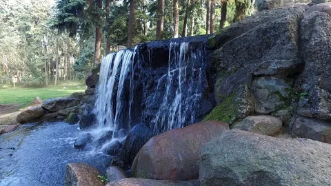 Small watherfall in a autumn garden Video stock 97350079