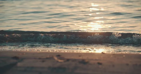 Small wave breaking ocean beach sunset slowmotion 4k 스톡 동영상 153500385