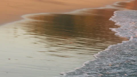 Small wave calmly rolling on the beach Stock Footage 232633489