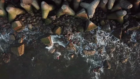 Small wave crashes on stones on the shore of the Baltic Sea in Liepaja, Latvia.  Stock Footage 143615429