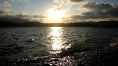 Small wave movement at sunset on the lake. Lake water moving in the wind Видео 291524908