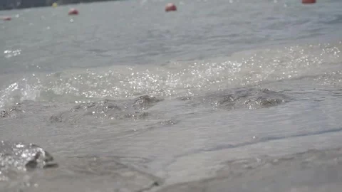 Small wave on the rocks at the edge of a lake, Log Stock Footage 240938837