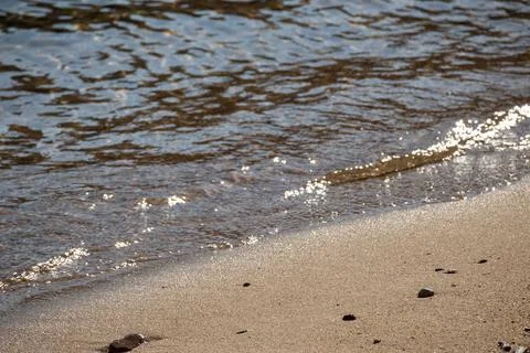 Small wave on sandy shore in Saint-Tropez Stock Photos