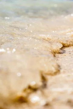 Small wave of the sea, throwing sand on beach. large, macro, bokeh Stock-Fotos