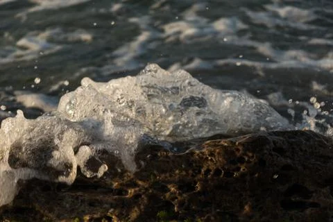 Small wave splash on rock Stock Photos