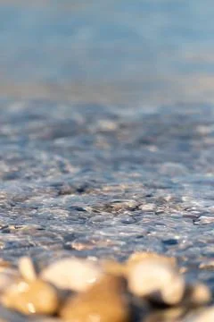 Small wave splashes over pebble Stock Photos